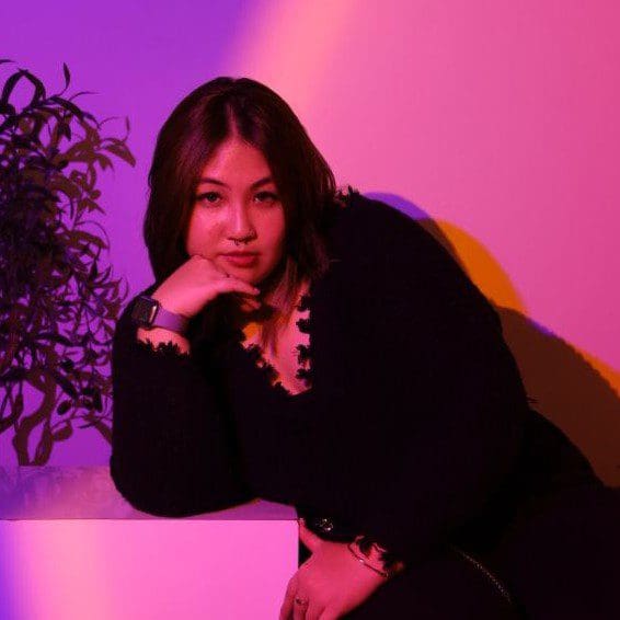 Zellyn Lo portrait against pink and purple gradient background
